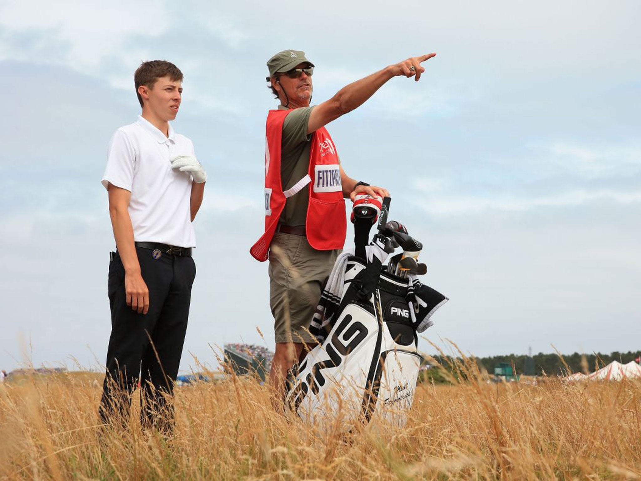 Matthew Fitzpatrick talks to caddie Lorne Duncan on the 18th hole
