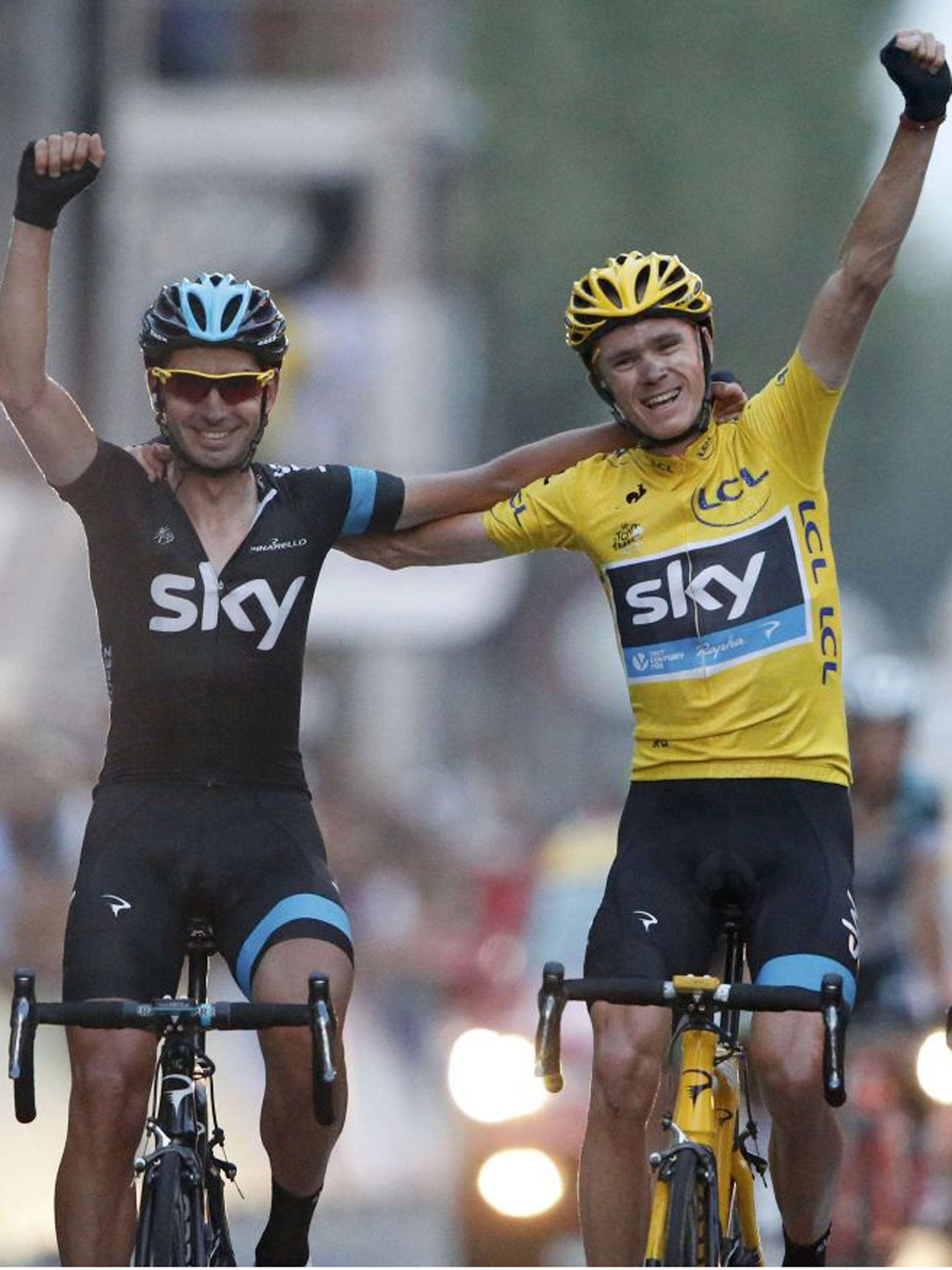 Chris Froome, right, crosses the line in Paris with Sky team-mate David Lopez Garcia yesterday