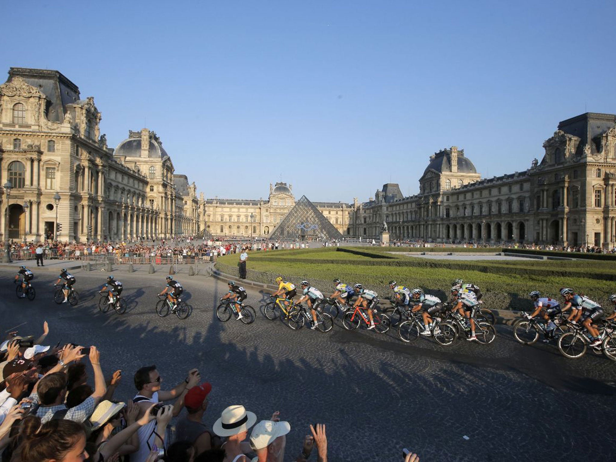 The peloton rides past The Louvre in yesterday’s final stage