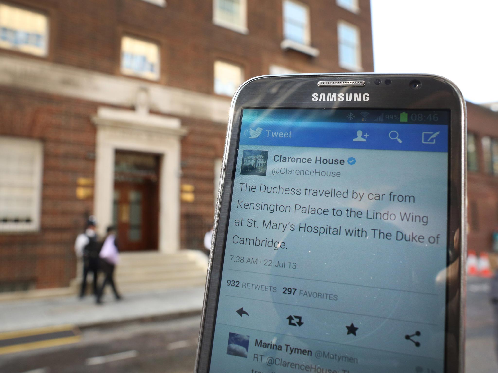 A mobile phone displays a Tweet from Clarence House outside St Mary's Hospital