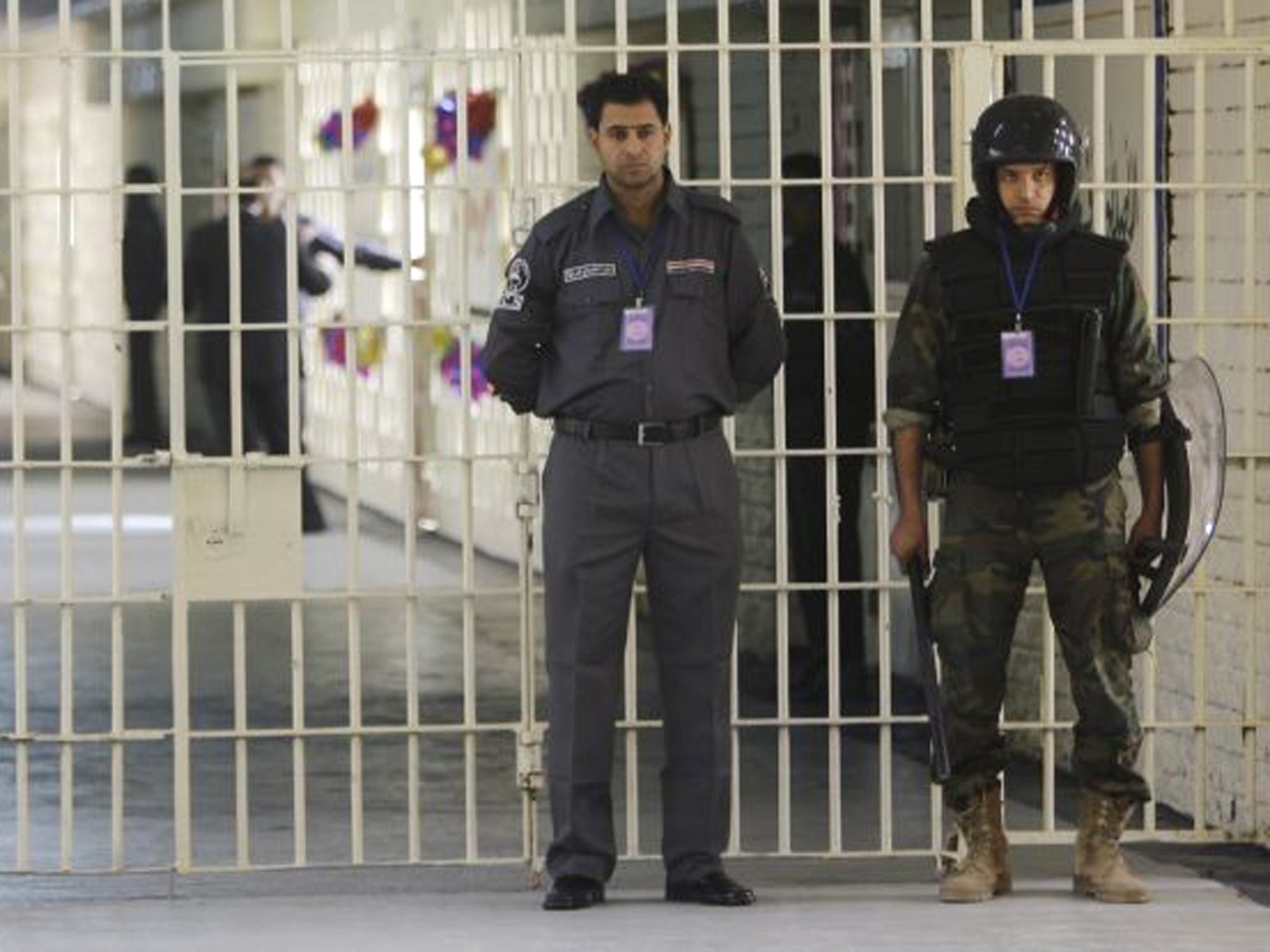 Guards stand at a cell block at the renovated Abu Ghraib prison, now renamed Baghdad Central Prison and run by Iraqis