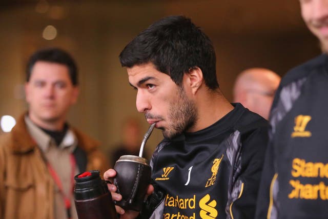 Luis Suarez walks to the team bus to attend training at the Grand Hyatt