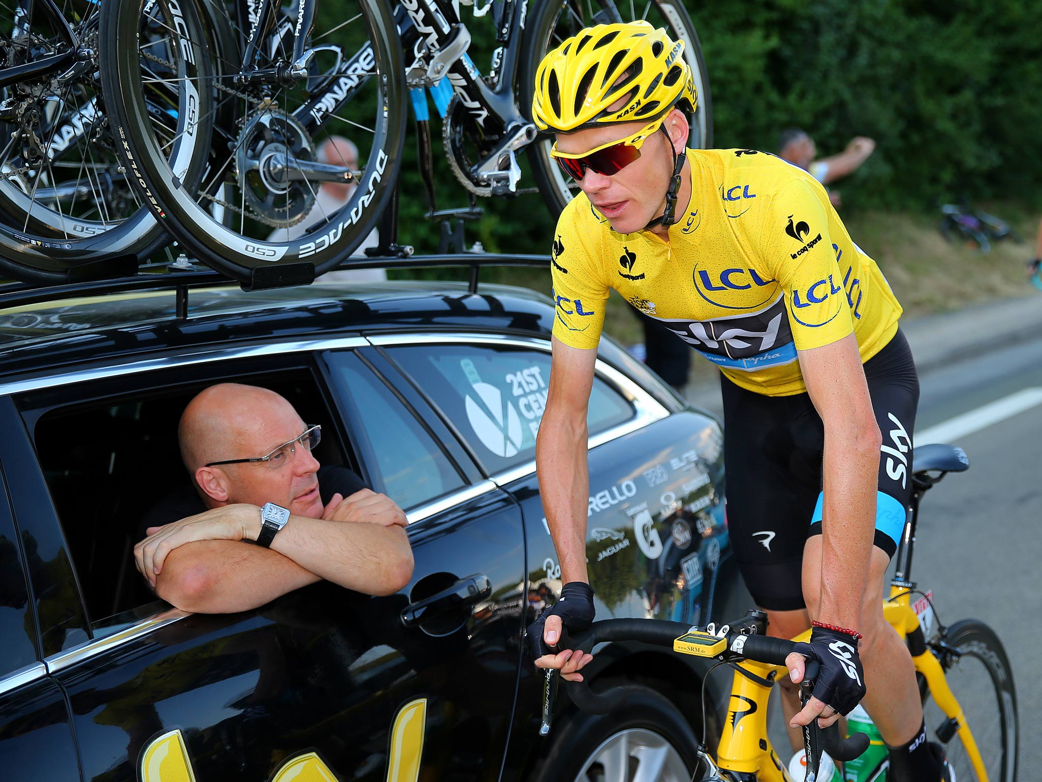 Sir Dave Brailsford speaks with the winner of the 2013 Tour de France, Chris Froome, during the final stage