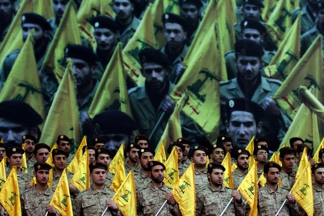 Shiite Muslims Hezbollah militants stand to attention