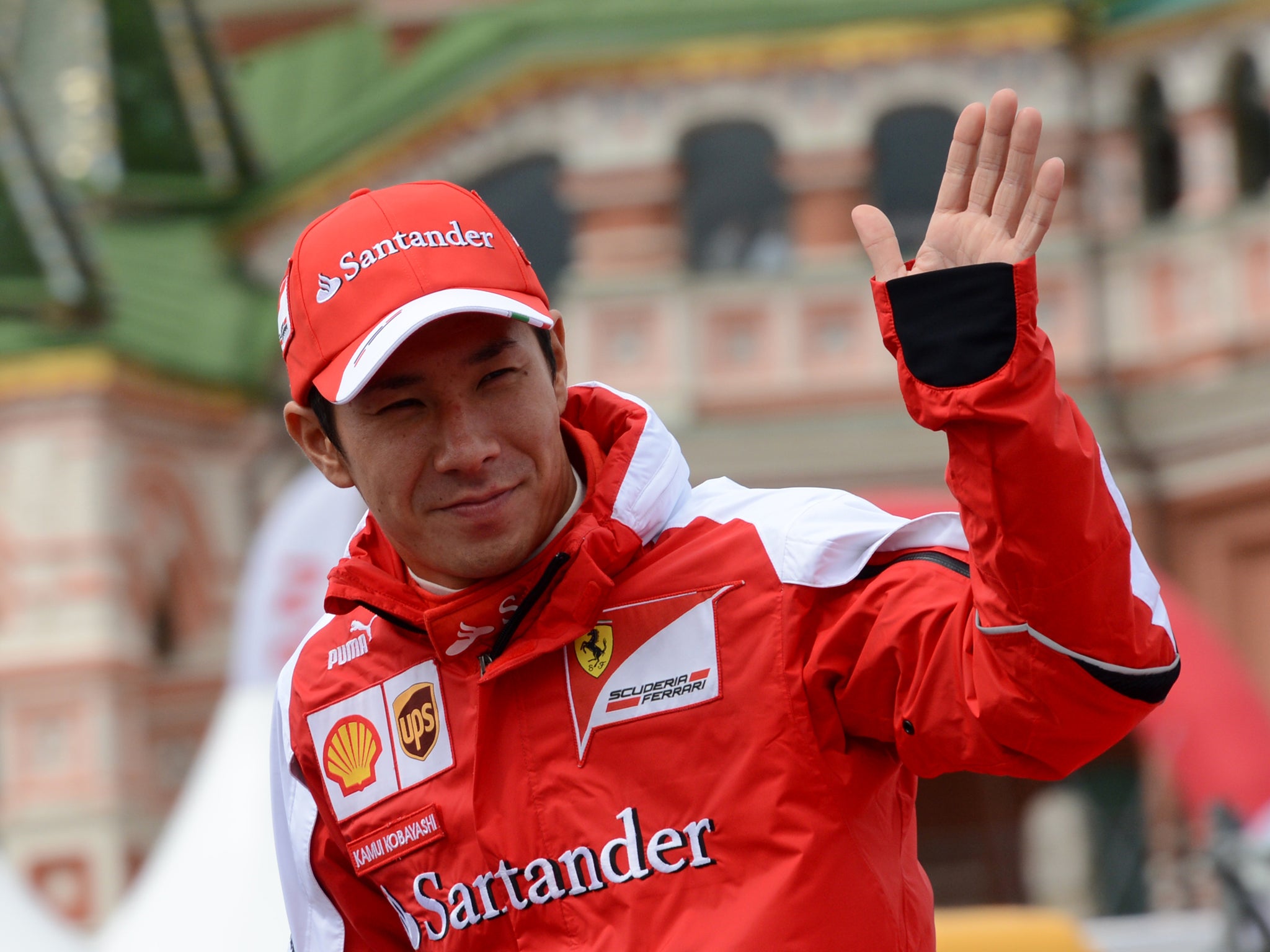 Kamui Kobayashi waves to the Russian crowd before a demo run on the streets of Moscow