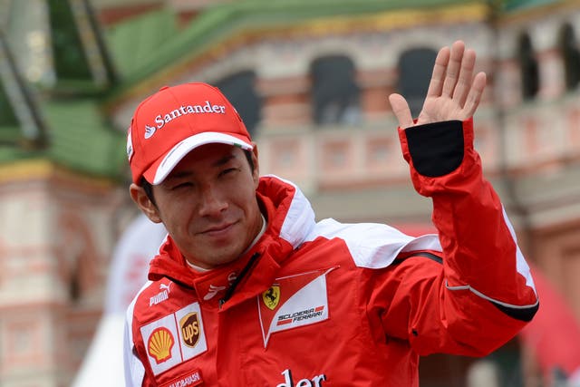Kamui Kobayashi waves to the Russian crowd before a demo run on the streets of Moscow