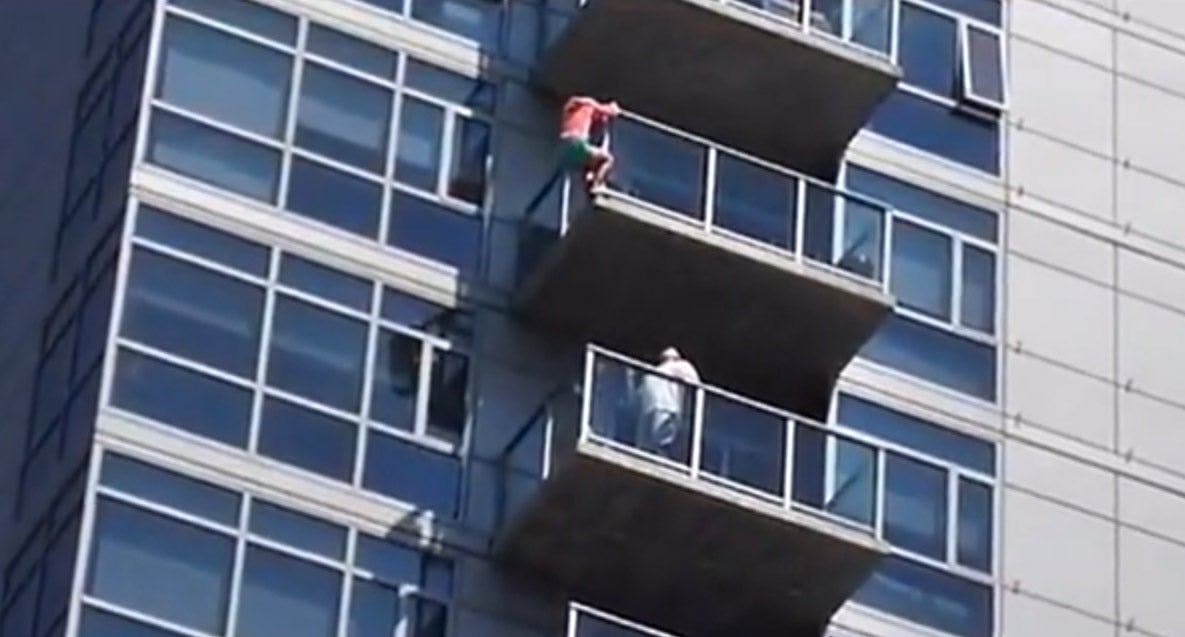 A woman dangling from a 14th floor balcony in San Diego was rescued by three stuntmen from the nearby Comic Con convention