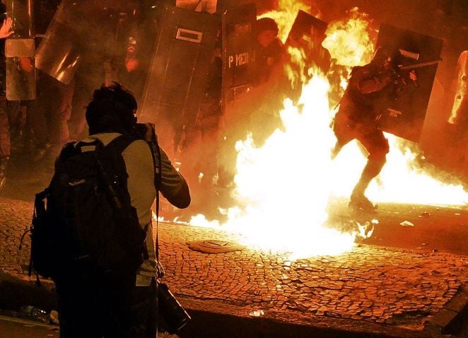 A photographer captures clashes between protesters and riot police in Rio de Janeiro