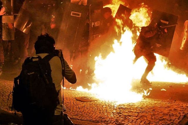 A photographer captures clashes between protesters and riot police in Rio de Janeiro