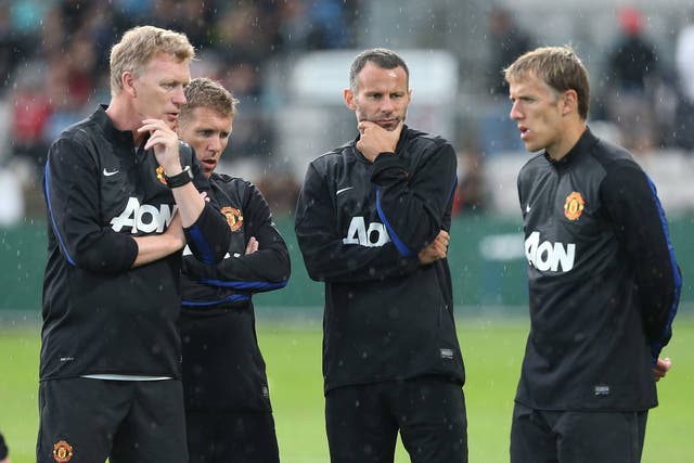 Manager David Moyes of Manchester United speaks to Assistant Manager Steve Round, Ryan Giggs and Coach Phil Neville 