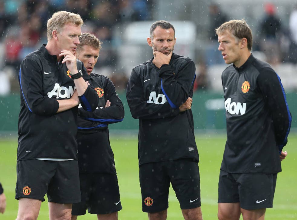 Manager David Moyes of Manchester United speaks to Assistant Manager Steve Round, Ryan Giggs and Coach Phil Neville