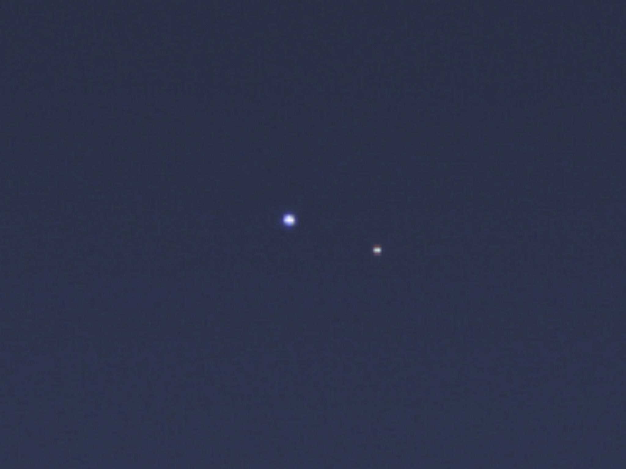 A rare look at Earth (left) and its moon from Saturn orbit