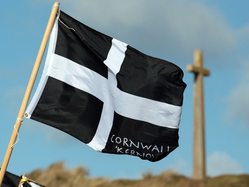 A Cornish flag flies over the dunes at Perranporth