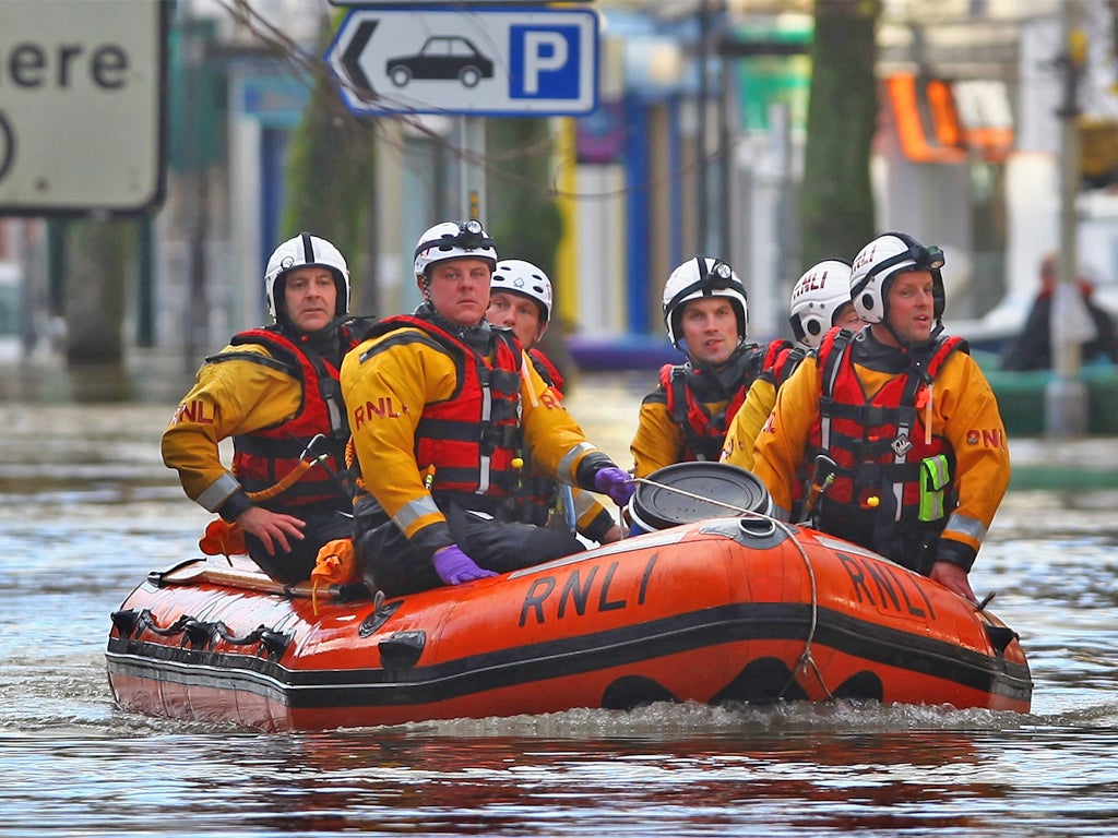 Rescue workers in the Lake District during the severe flooding in 2009 (Getty)