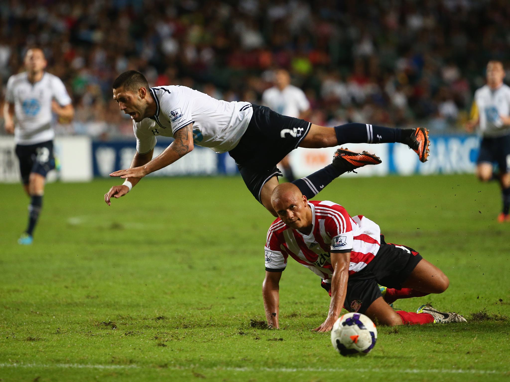 Clint Dempsey of Tottenhan Hotspur is tackled by Wes Brown of Sunderland during the Barclays Asia Trophy semi final