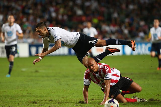 Clint Dempsey of Tottenhan Hotspur is tackled by Wes Brown of Sunderland during the Barclays Asia Trophy semi final 
