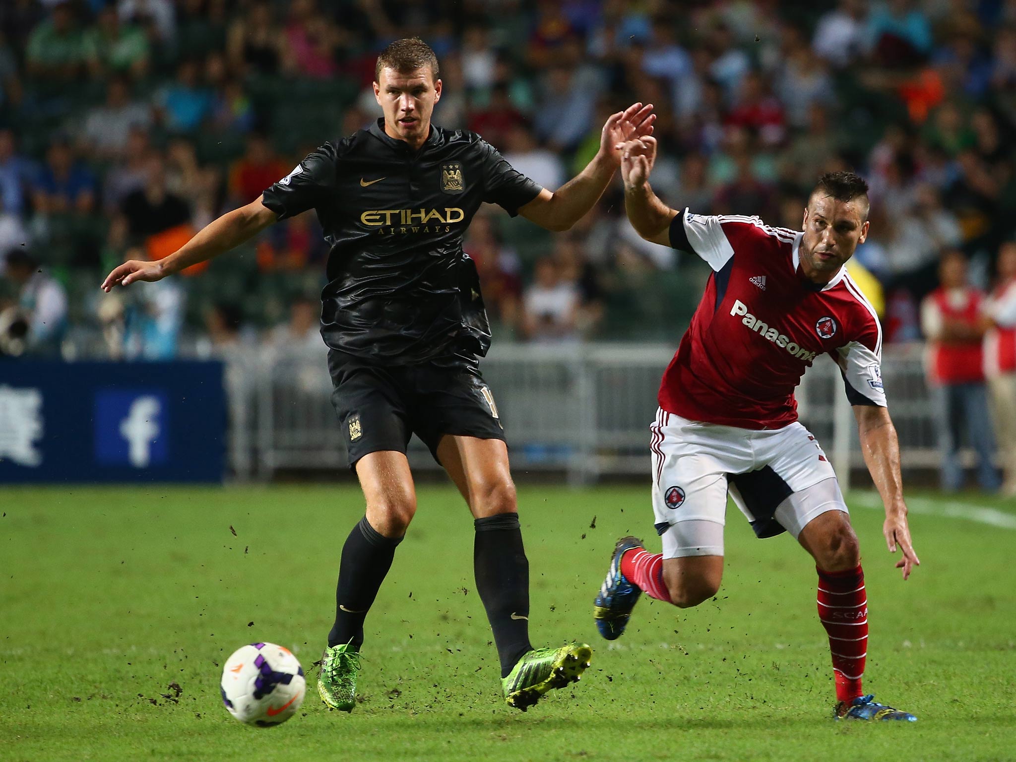 Edin Dzeko in action for Manchester City against South China