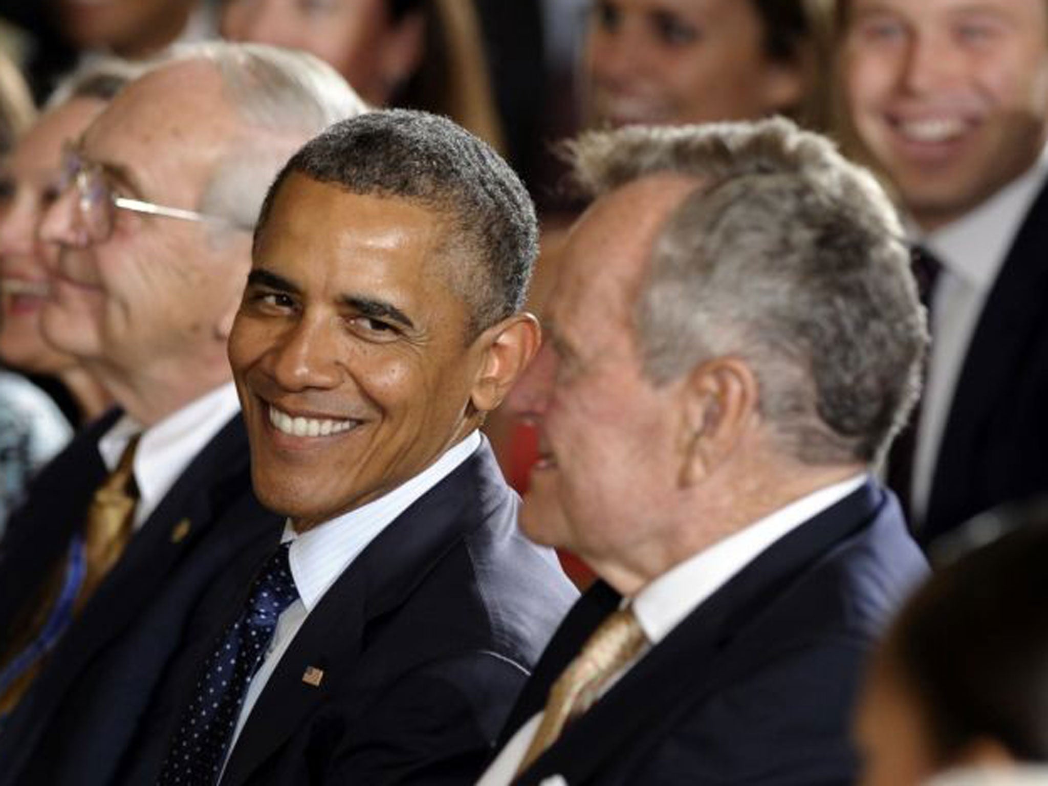 President George Bush Senior, still with his hair, next to Barack Obama