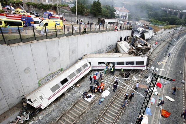 Derailed cars at the site of a train accident near the city of Santiago de Compostela