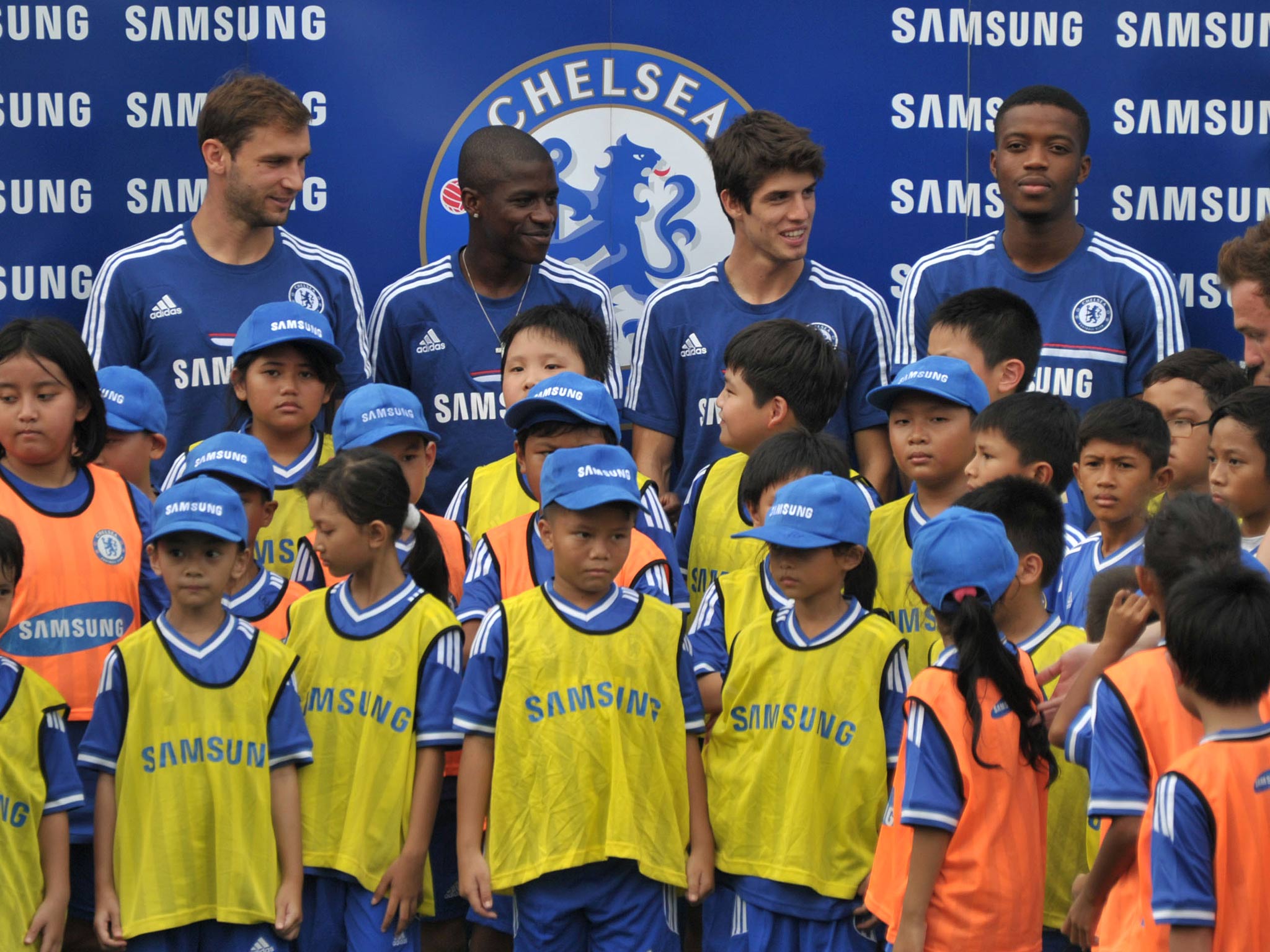 Branislav Ivanovic, Ramires, Lucas Piazon and Nathaniel Chalobah pose for a photo with children at a coaching clinic session
