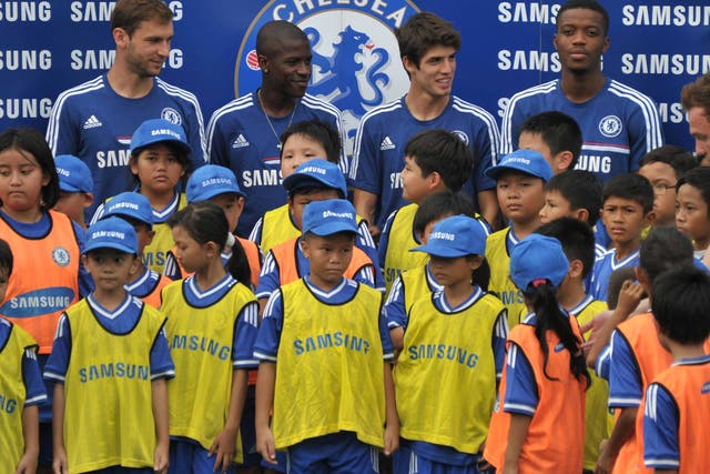Branislav Ivanovic, Ramires, Lucas Piazon and Nathaniel Chalobah pose for a photo with children at a coaching clinic session 