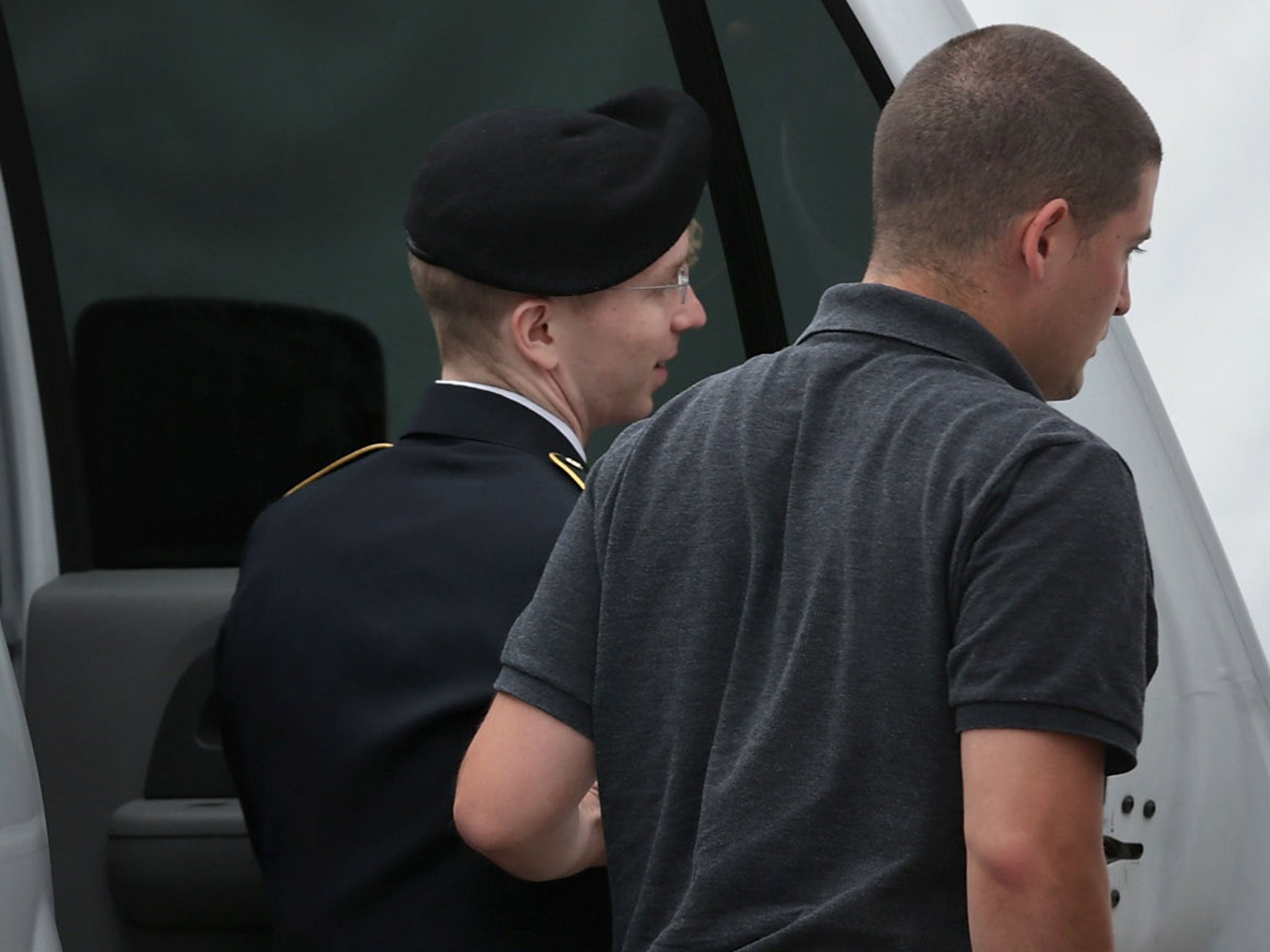 Bradley Manning is led by a military police officer as he arrives for trial at Fort Meade