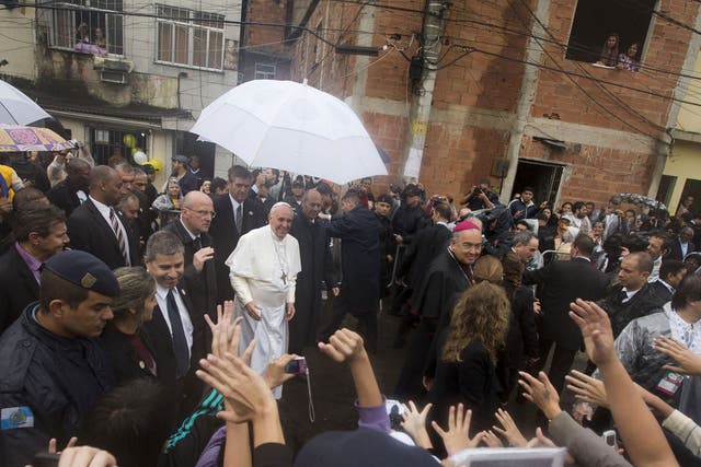 Pope Francis receives a warm welcome as he visits the Varginha slum