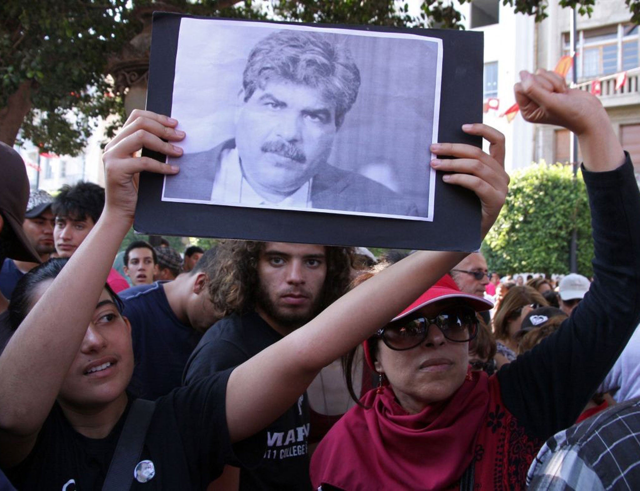 Tunisians outside the interior ministry after the assassination of leading opposition figure Mohamed Brahmi