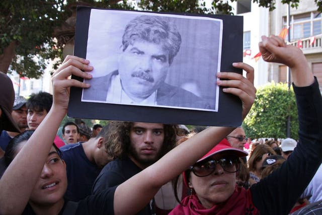 Tunisians outside the interior ministry after the assassination of leading opposition figure Mohamed Brahmi 