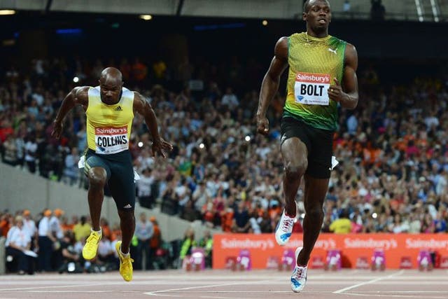 Usain Bolt crosses the line first ahead of Kim Collins