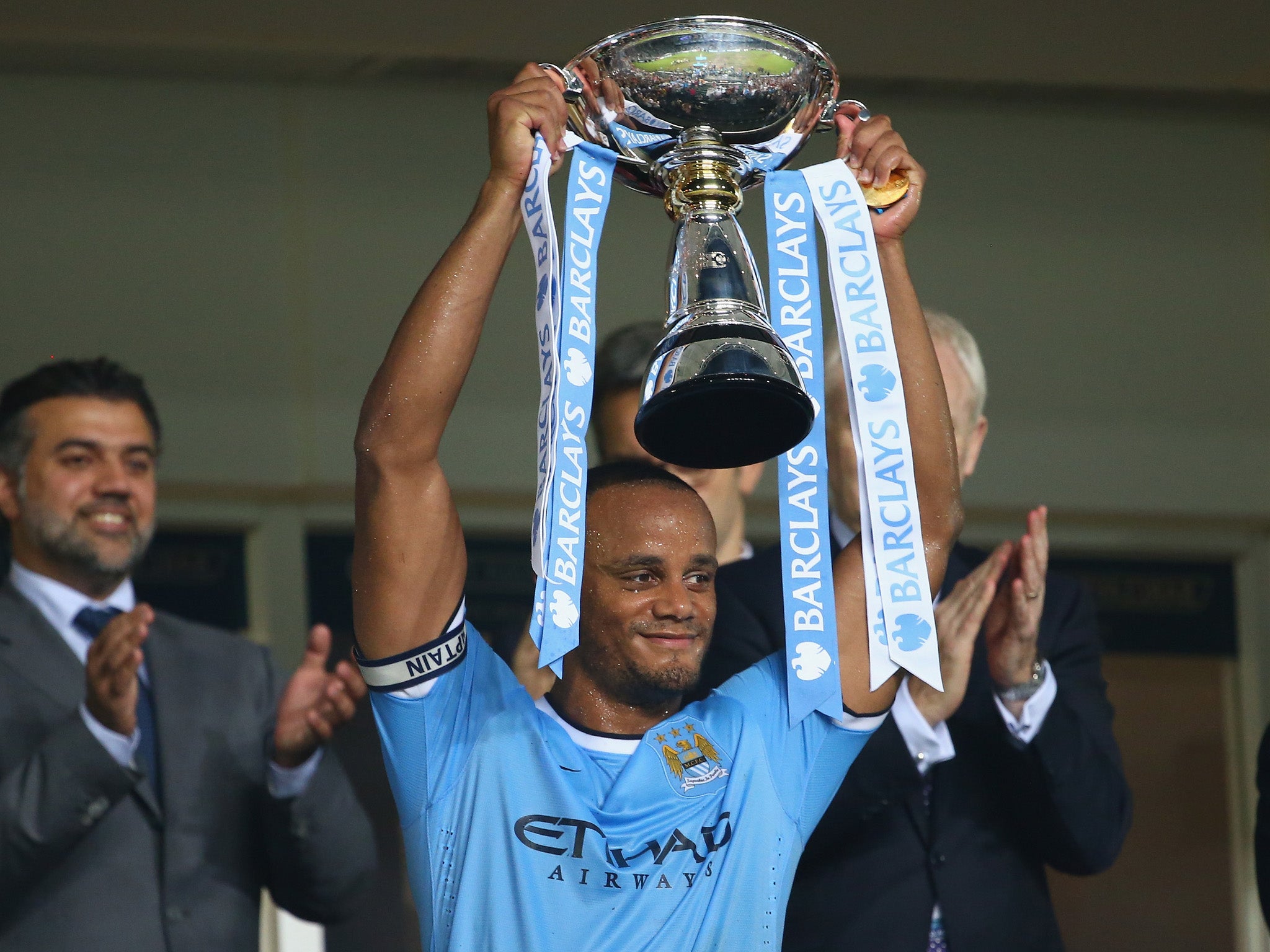 Vincent Kompany of Mancester City holds aloft the Asia trophy after Mancester City defeated Sunderland at the Barclays Asia Trophy Final