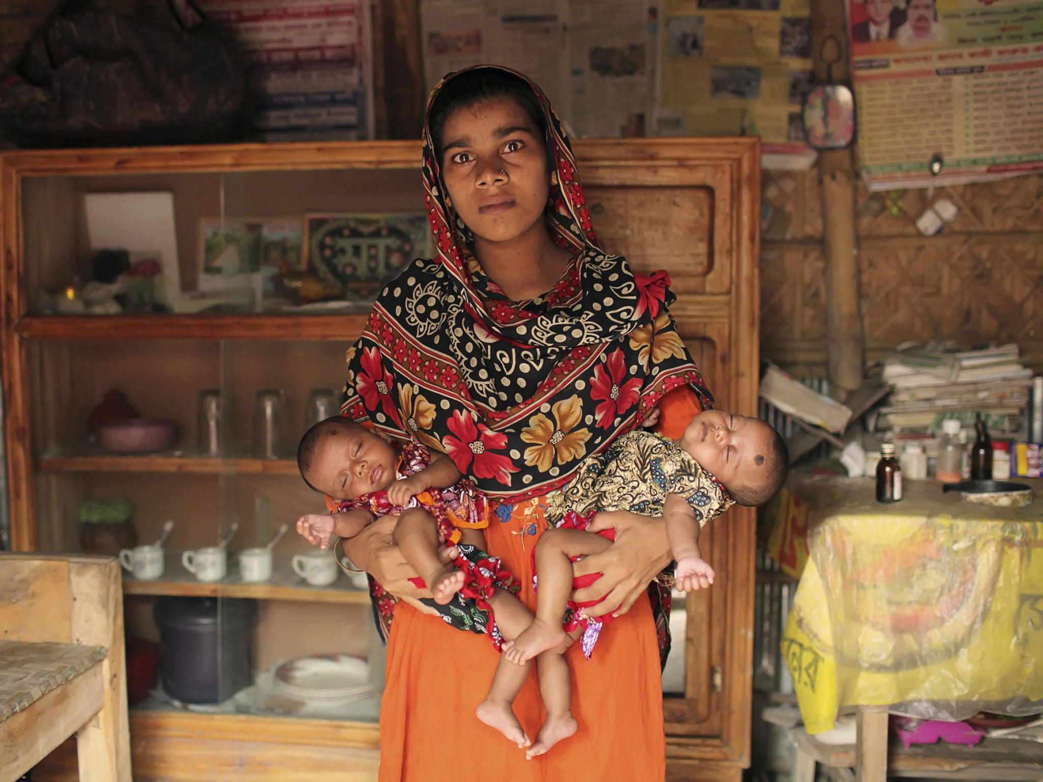 Afroza, now 18, with twins Diya and Habib. Her birth was not registered, allowing her parents to falsify her age on a fake birth certificate; the legal age to wed in Bangladesh is 18 – Afroza was 15