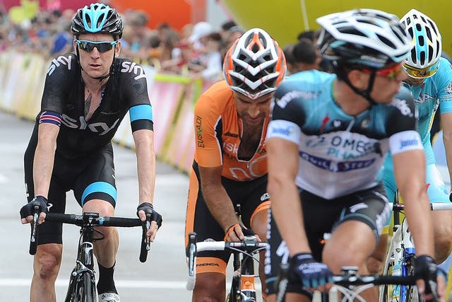 Back pedalling: Sir Bradley Wiggins (left) finishes the first stage