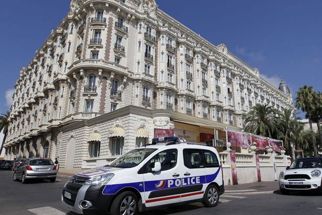 A police car stands outside the Carlton Intercontinental Hotel in Cannes