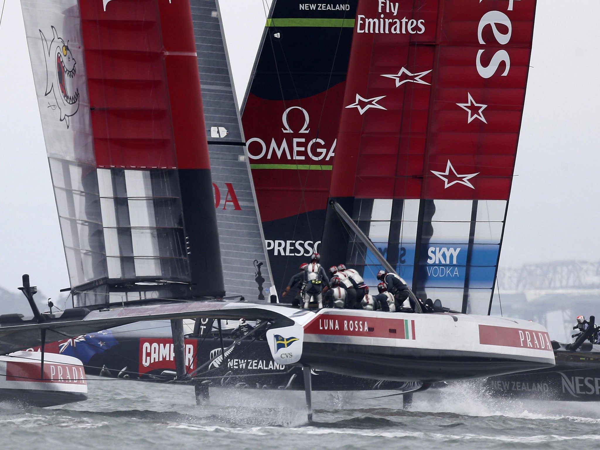 Emirates Team New Zealand, right, and Luna Rossa Challenge race towards the second turning mark as they compete in a seven-leg course in the first race of Round 5 of the Louis Vuitton Cup