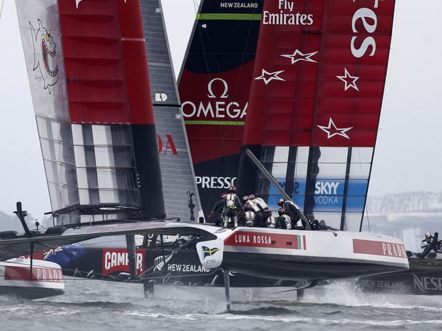 Emirates Team New Zealand, right, and Luna Rossa Challenge race towards the second turning mark as they compete in  a seven-leg course in the first race of Round 5 of the Louis Vuitton Cup