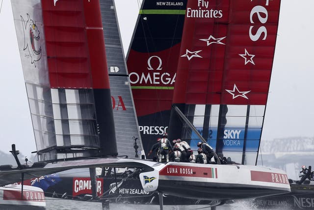 Emirates Team New Zealand, right, and Luna Rossa Challenge race towards the second turning mark as they compete in  a seven-leg course in the first race of Round 5 of the Louis Vuitton Cup
