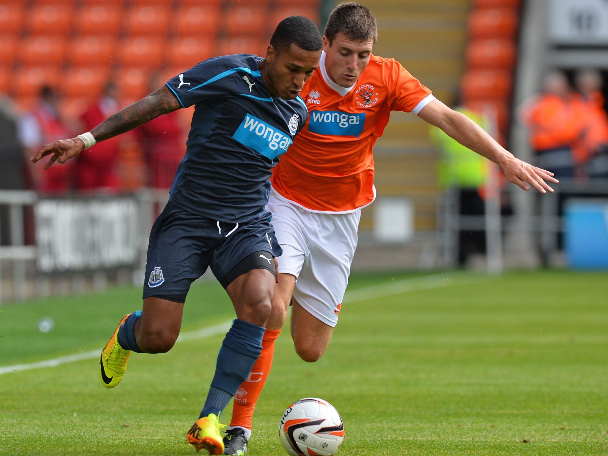 Newcastle’s Sylvain Marveaux, left, and Bobby Grant of Blackpool, right