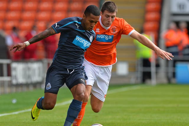 Newcastle’s Sylvain Marveaux, left, and Bobby Grant of Blackpool, right