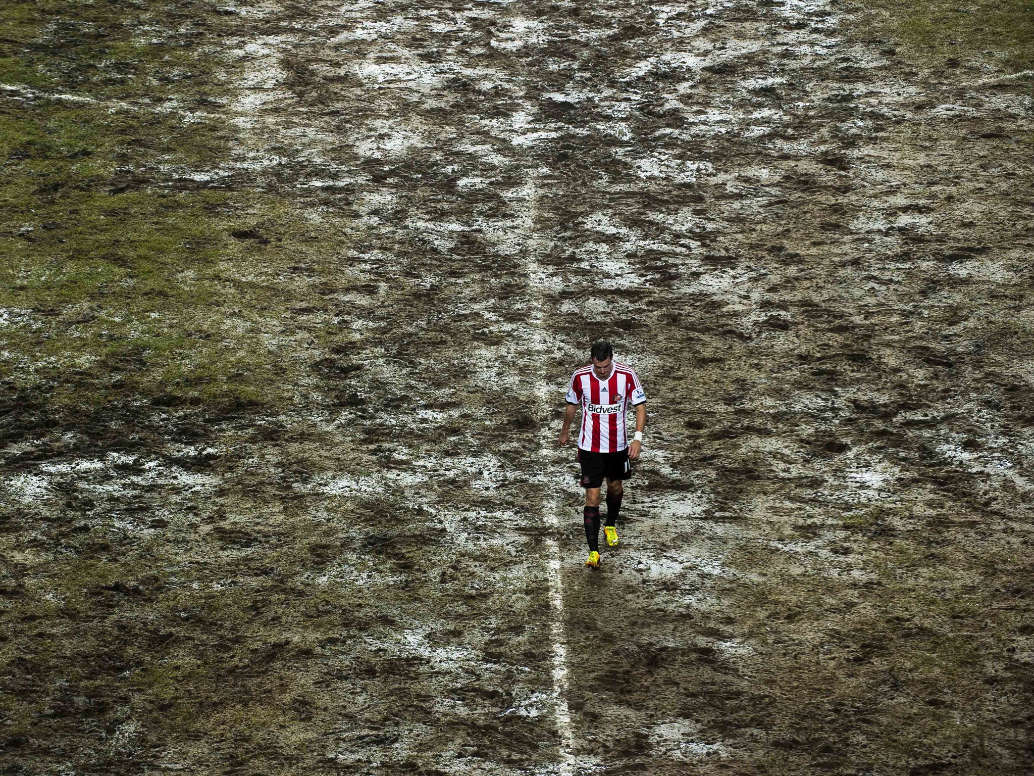 Adam Johnson trudges off the muddy Hong Kong Stadium pitch during the Barclays Asia Trophy