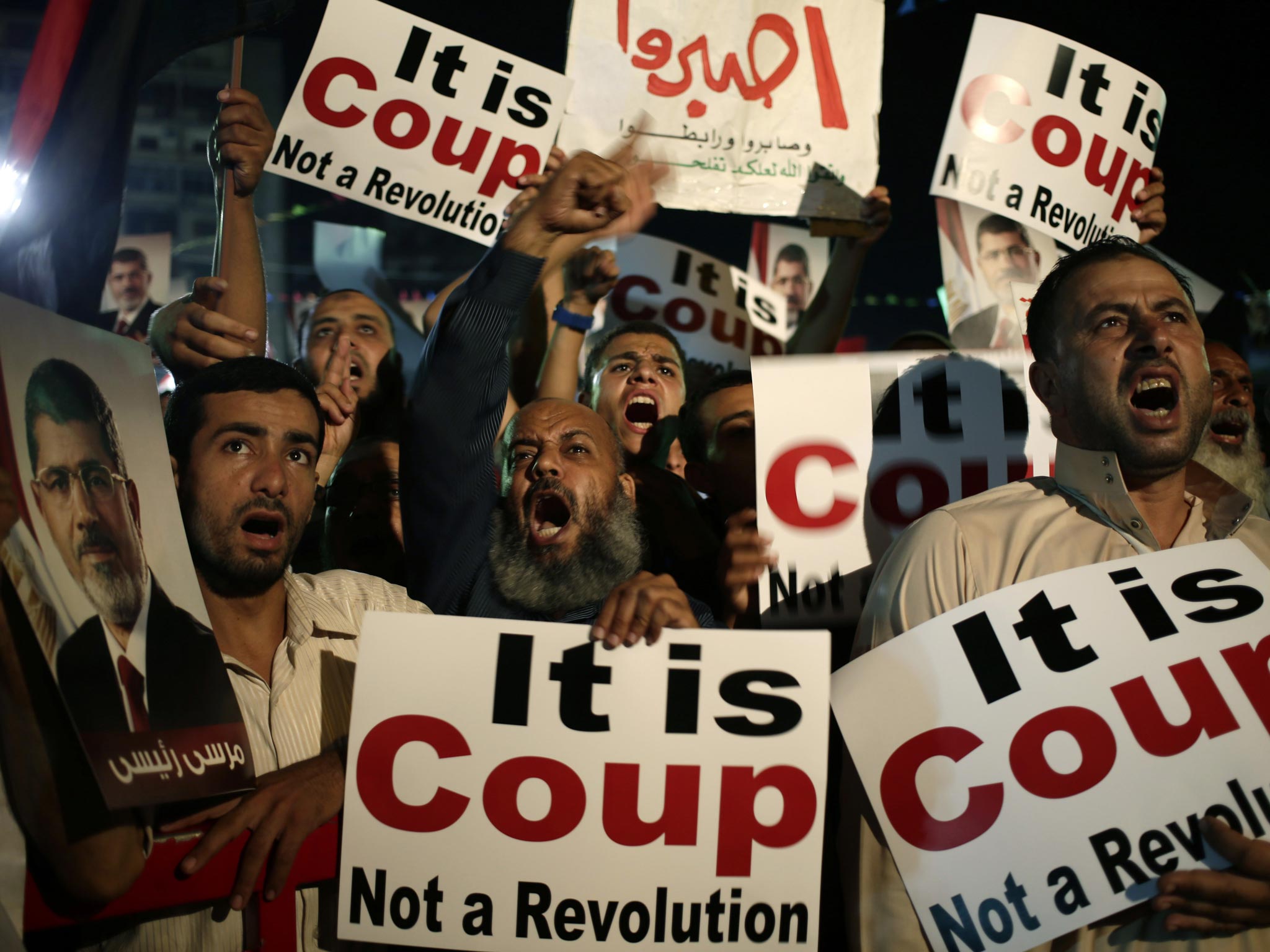 Supporters of Egypt's ousted President Mohammed Morsi chants slogans against Egyptian Defense Minister General Abdel-Fattah el-Sissi at Nasr City