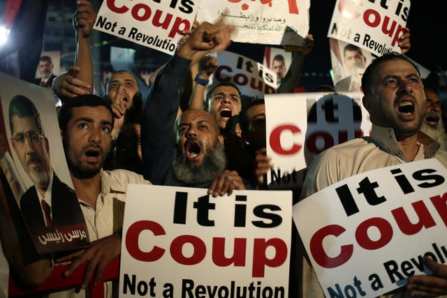 Supporters of Egypt's ousted President Mohammed Morsi chants slogans against Egyptian Defense Minister General Abdel-Fattah el-Sissi at Nasr City