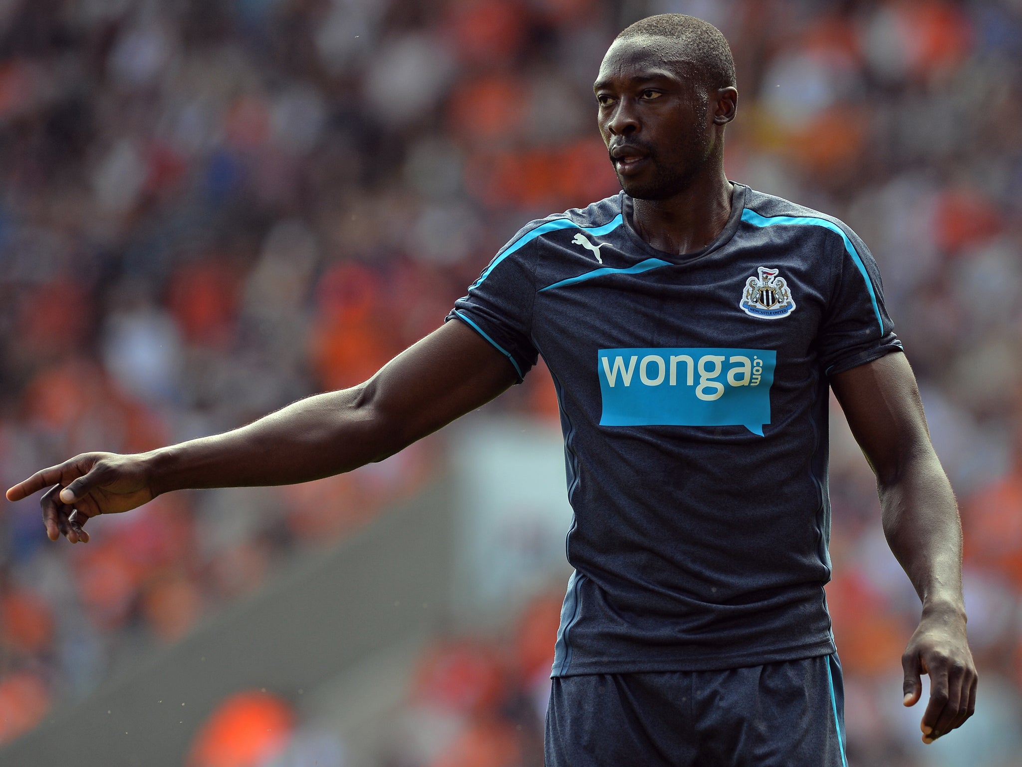 Shola Ameobi in pre-season action against Blackpool wearing the controversial 'Wonga' sponsored shirt that has seen a dispute arise with Pappiss Demba Cisse