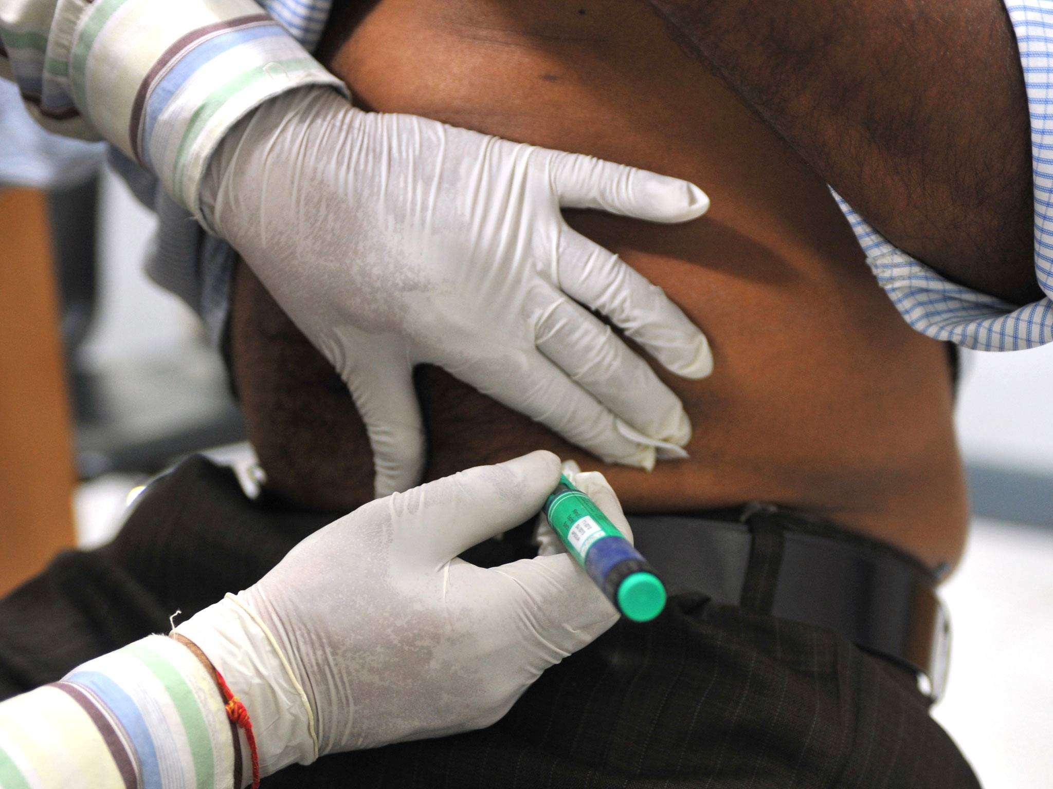 A medical assistant administers an insulin shot to a diabetes patient
