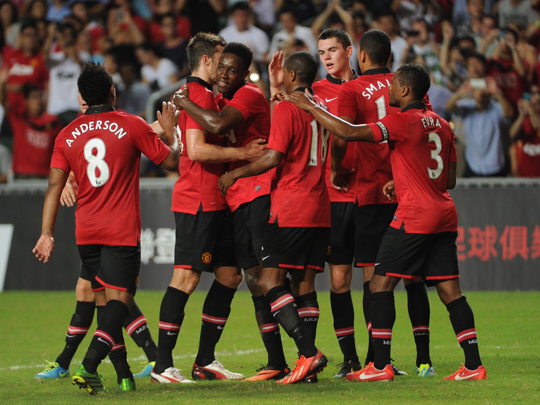 Danny Welbeck celebrates with the rest of the Manchester United team after he opens the scoring against Kitchee FC