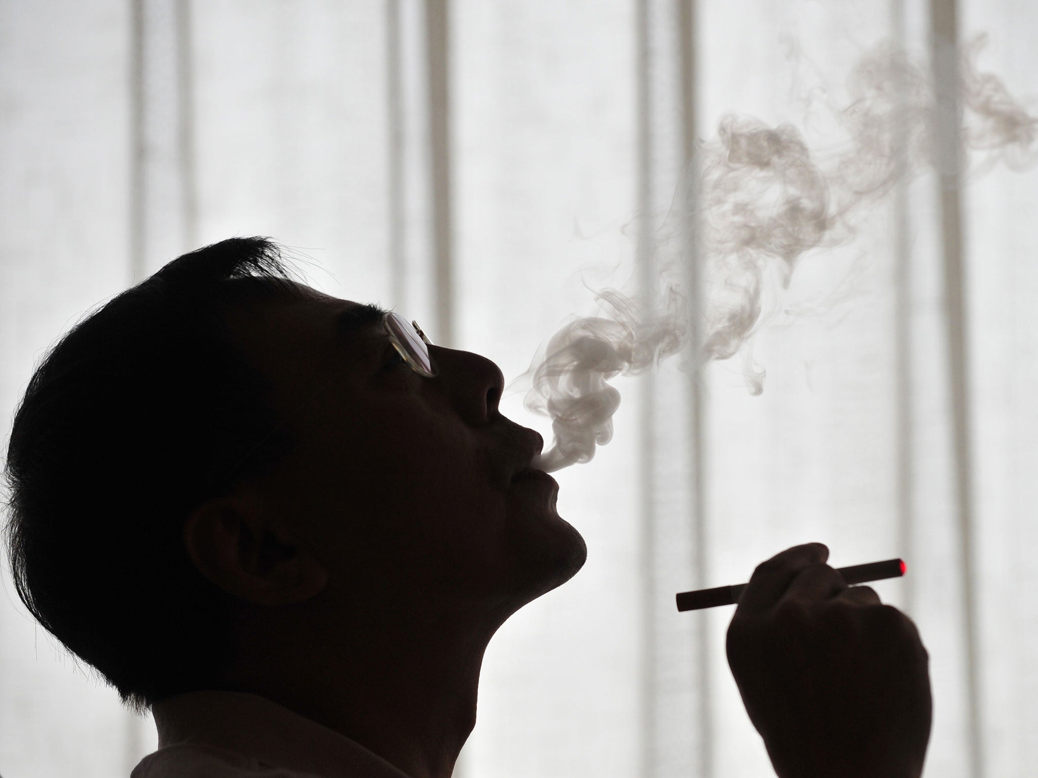 The inventor of the electronic cigarette, Hon Lik smoking his invention in Beiijng in 2009