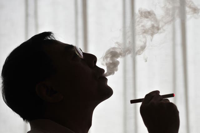 The inventor of the electronic cigarette, Hon Lik smoking his invention in Beiijng in 2009