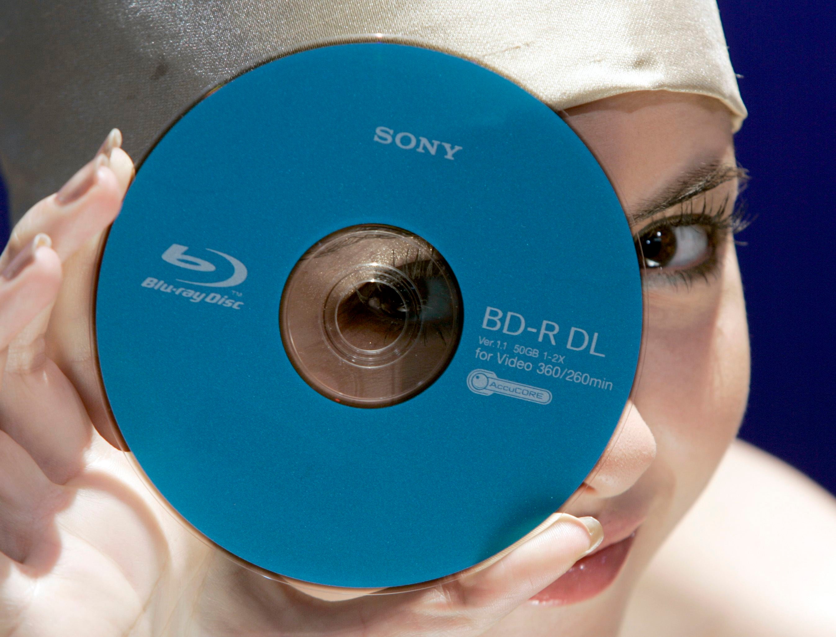 A model displays a Sony Corp's new 50 gigabyte (GB) Blue-ray disk during an unveiling in Tokyo September 12, 2007. Sony said it will launch four models of new Blu-ray high-definition optical disc recorders in November in Japan, as its format battle with t