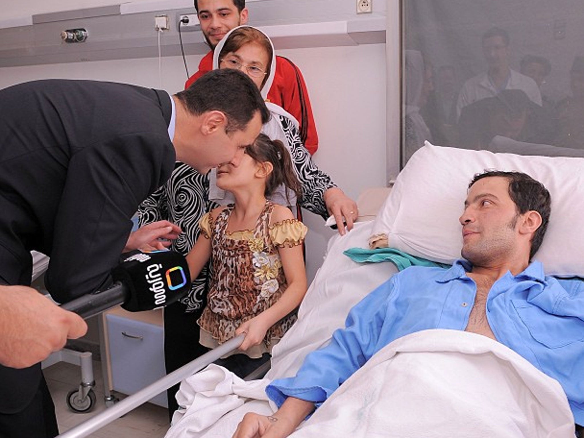 President Bashar al-Assad visits a sick man is hospital