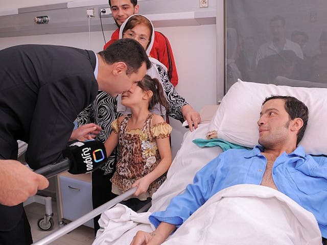 President Bashar al-Assad visits a sick man is hospital